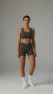 AIRE Sculpt+ Scrunch-Bum Shorts in brown, showcasing fitted high-waist design and sculpting fabric on a model.