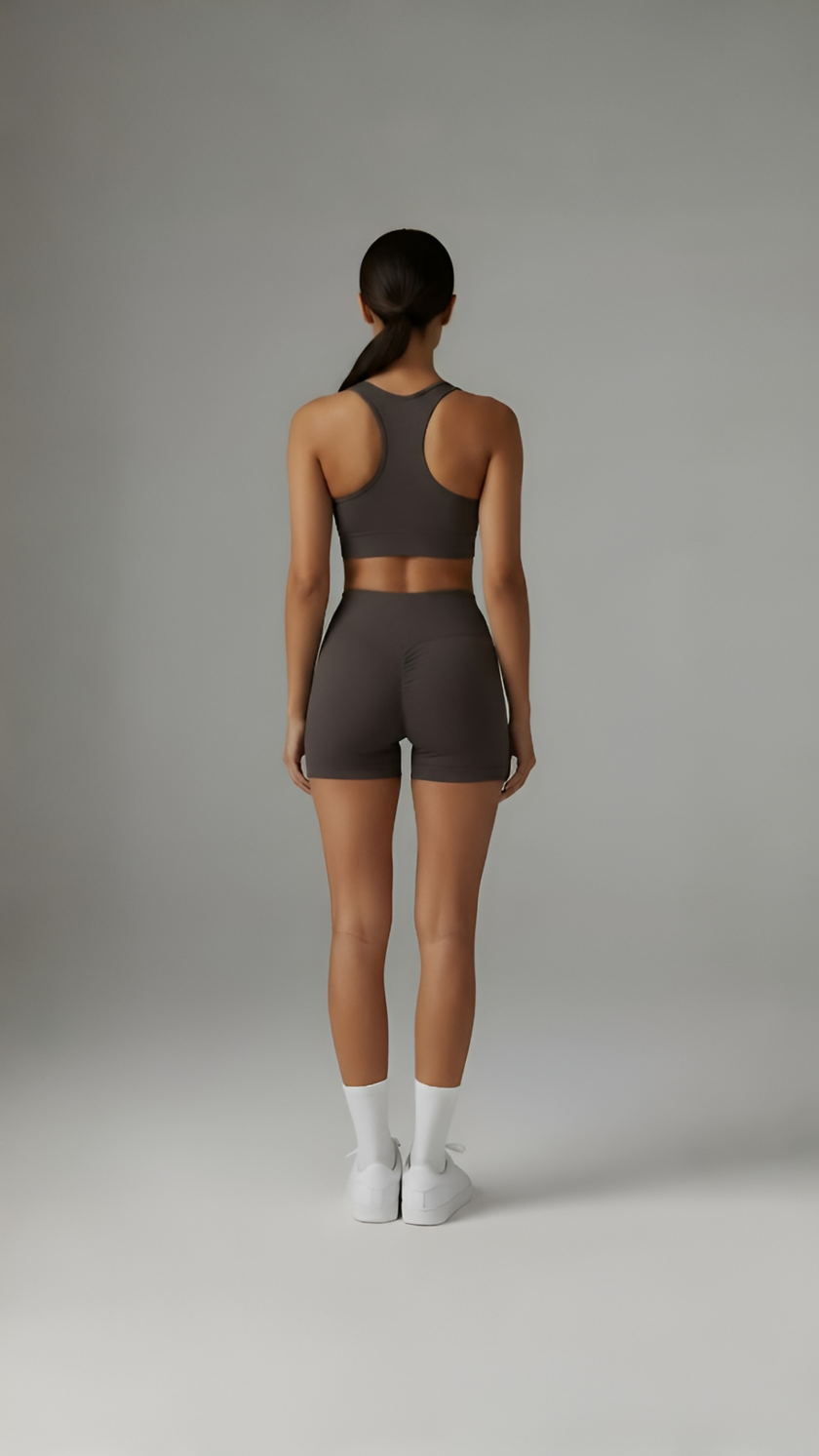 AIRE Sculpt+ Scrunch-Bum Shorts in brown, showing the high-waisted design and textured fabric for sculpting and contouring.