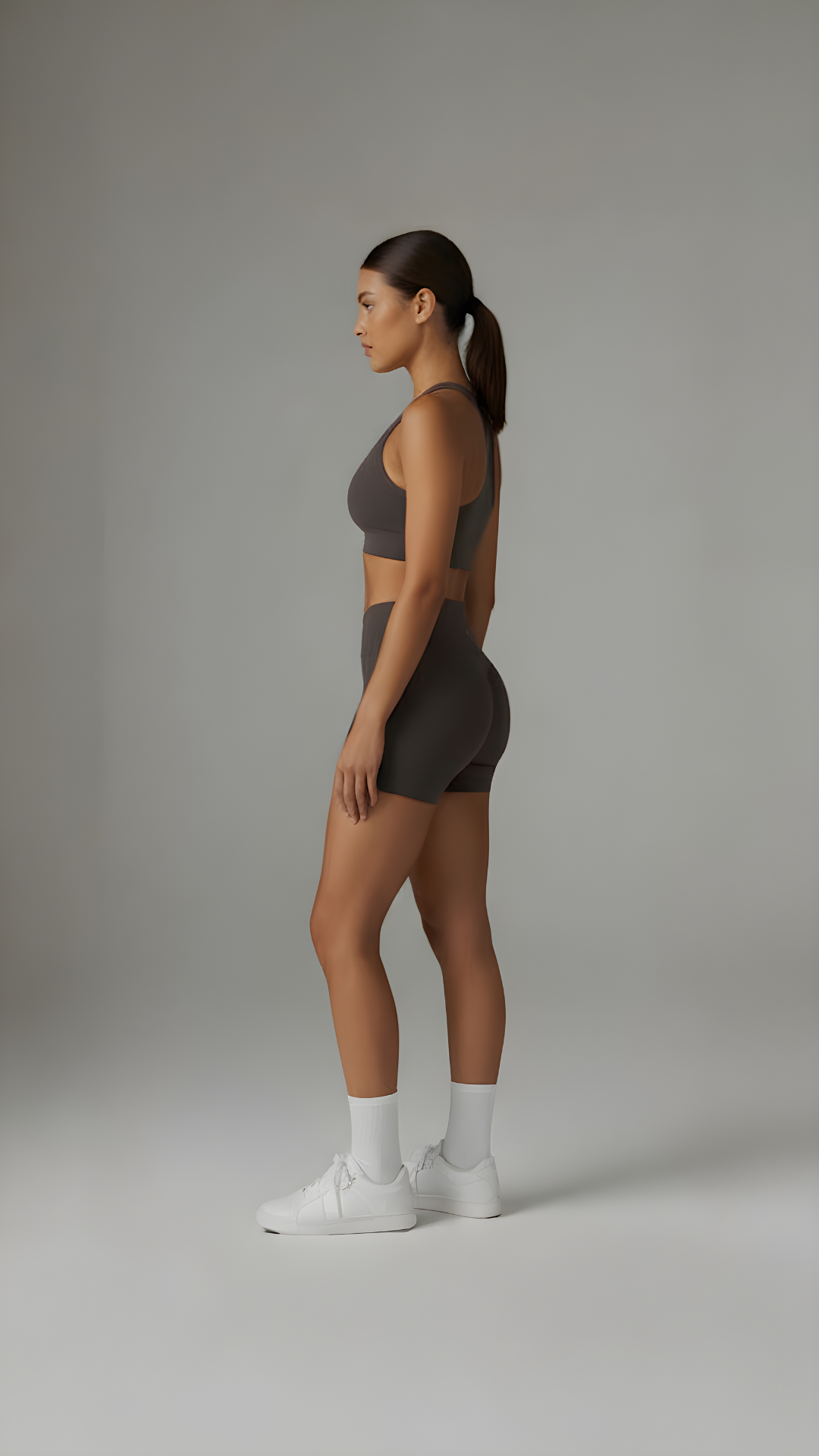 A close-up of brown Sculpt+ Scrunch-Bum Shorts by AIRE, showcasing the sculpting fabric and scrunch detail at the back.