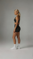 AIRE Sculpt+ Scrunch-Bum Shorts in black, high-waisted with a sculpting fit and ruched back design for enhanced curves.