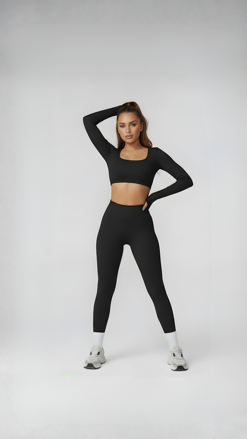 Woman wearing black long sleeve crop top and high-waisted leggings, athleisure outfit