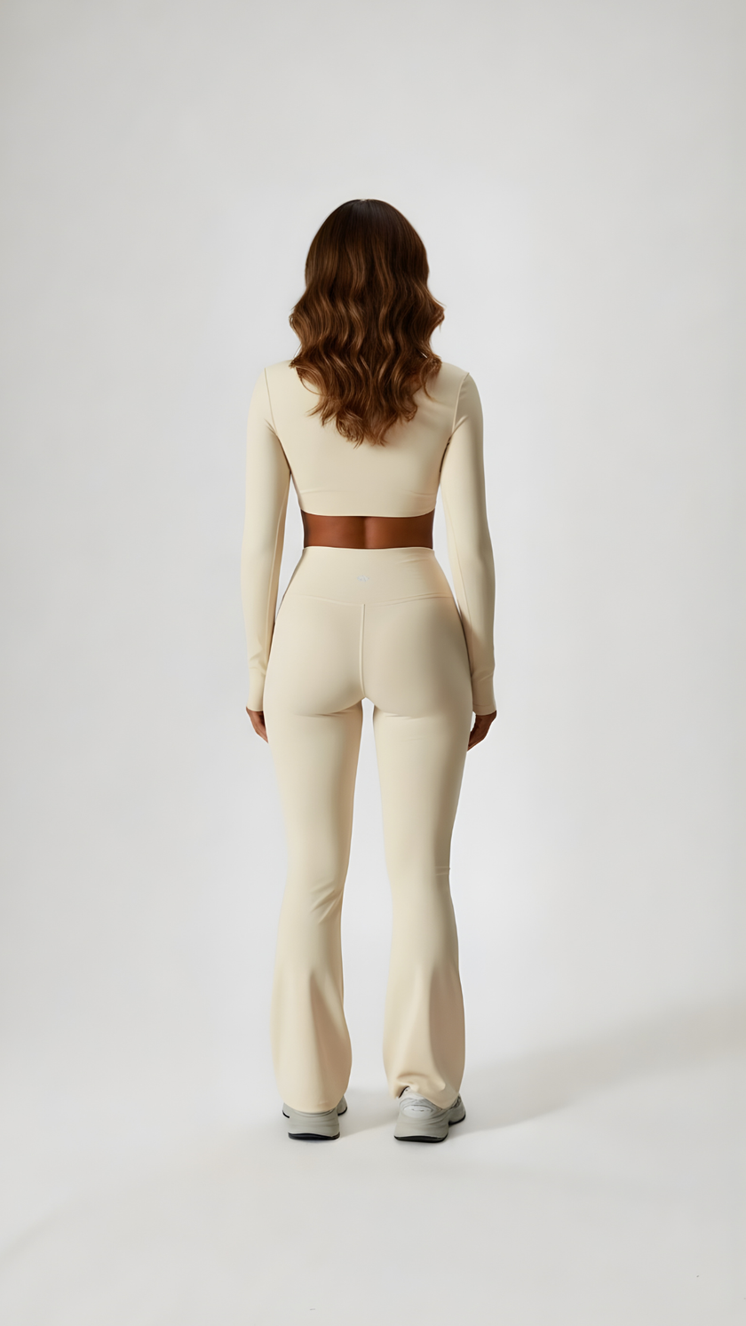 Woman wearing beige long sleeve athleisure set, full length, back view