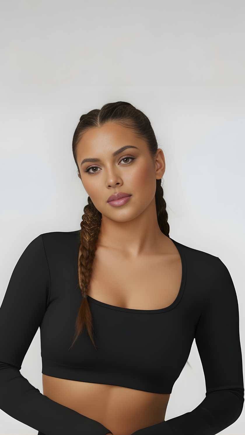 Woman wearing black long sleeve crop top with scoop neck, athleisure activewear style