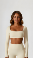 Woman wearing cream long sleeve crop top and high-waisted leggings, athleisure apparel